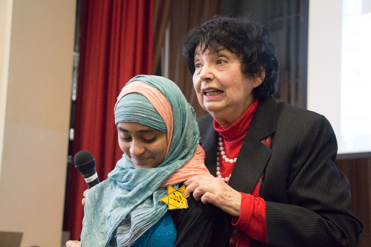 After her presentation about surviving the Holocaust, Inge Auerbacher pins a symbolic yellow star on Najum Ali, a student at Ditmas Junior High School