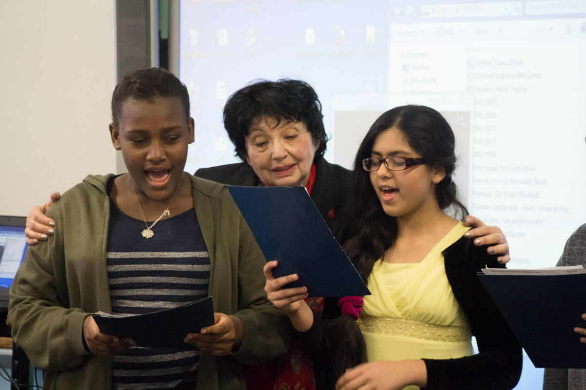 Inge Auerbacher joins singers from Ditmas Junior High School during one of Christopher Nolan's social studies classes