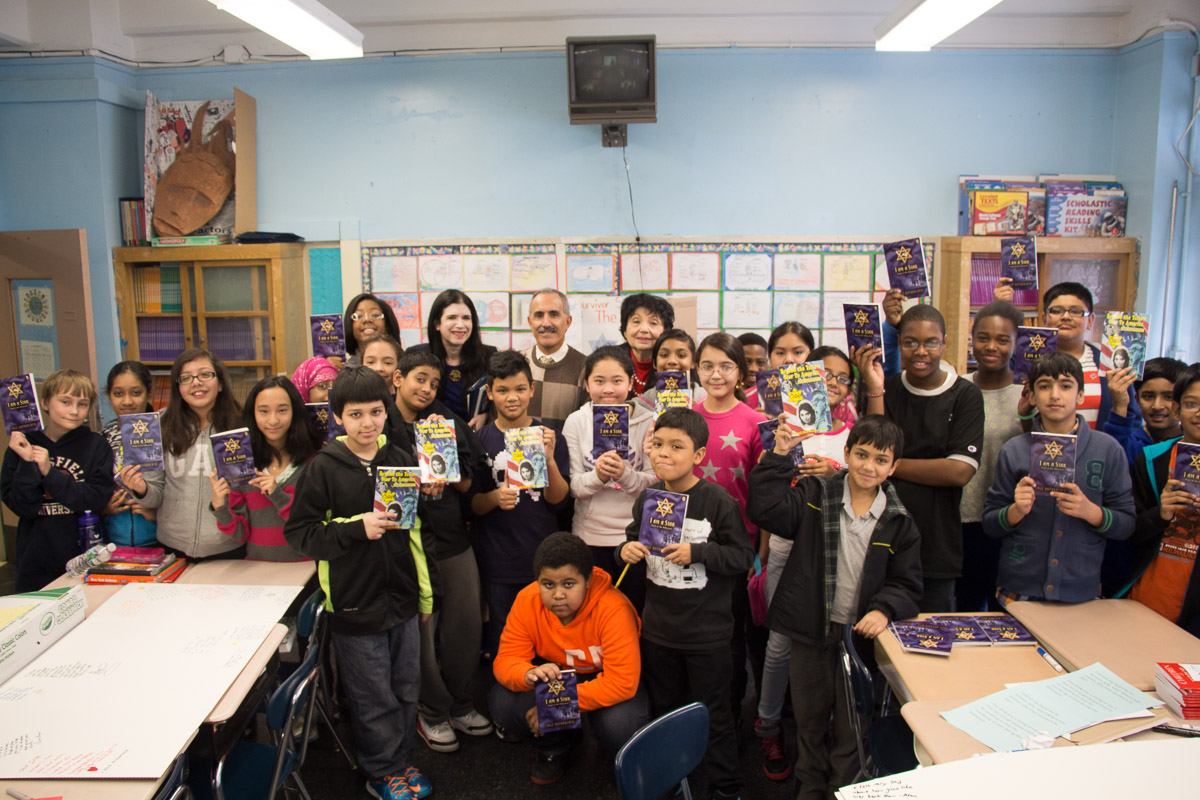 Students at Ditmas Junior High School welcome Holocaust survivor Inge Auerbacher to their classroom on February 3, 2014.
