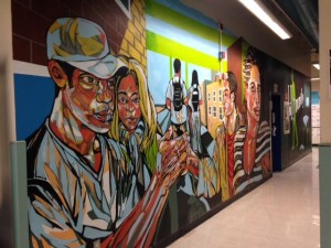 Edwards walks through the hallways at Aspirations, engaged and ready to graduate.  Above, a mural at the school inspires its students. Photo By: Annum Khan