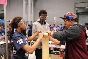 Students put together bumpers for the robot, which display their team number at the competition.