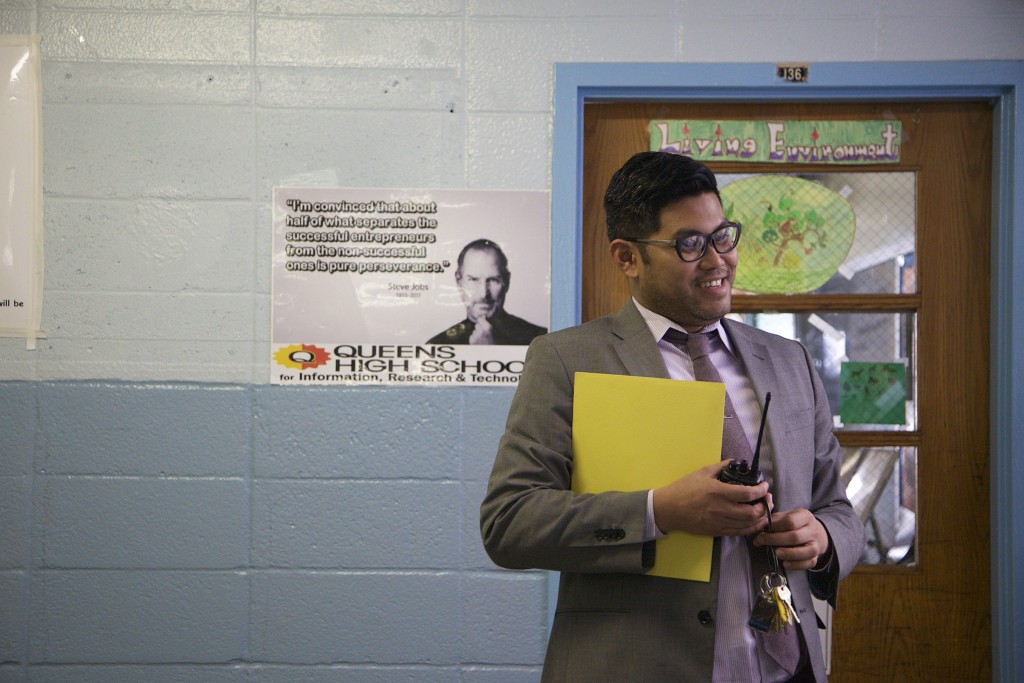 Principal Carl Manalo speaks with a teacher in the hallway of QIRT.