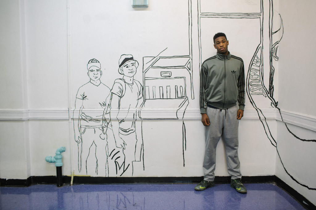 Collegiate junior Dante Tyson, 16, stands underneath a sketch of the school scanner. (Photo: Cassandra Giraldo)